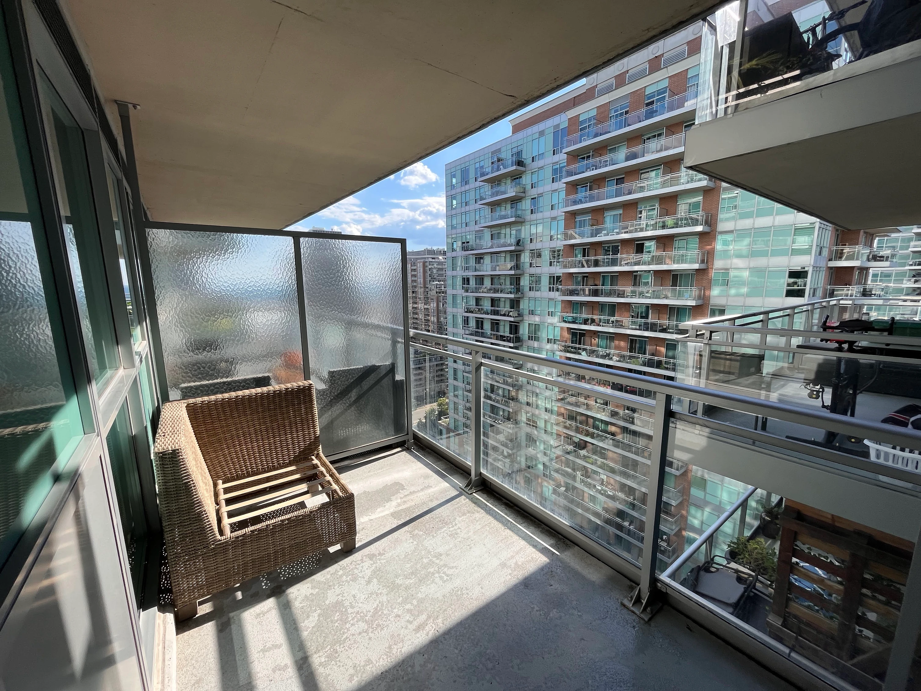 Clean condo balcony with woven chair