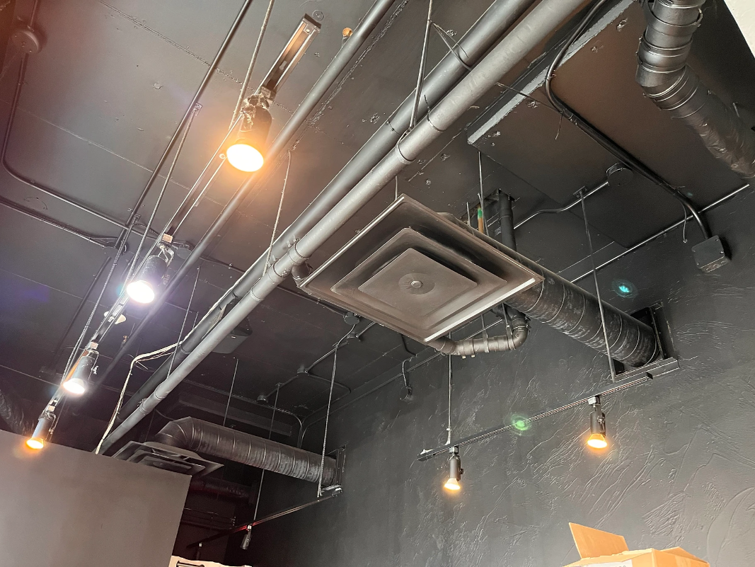 Close up of clean ceiling, light fixtures, and ventilation of downtown bar