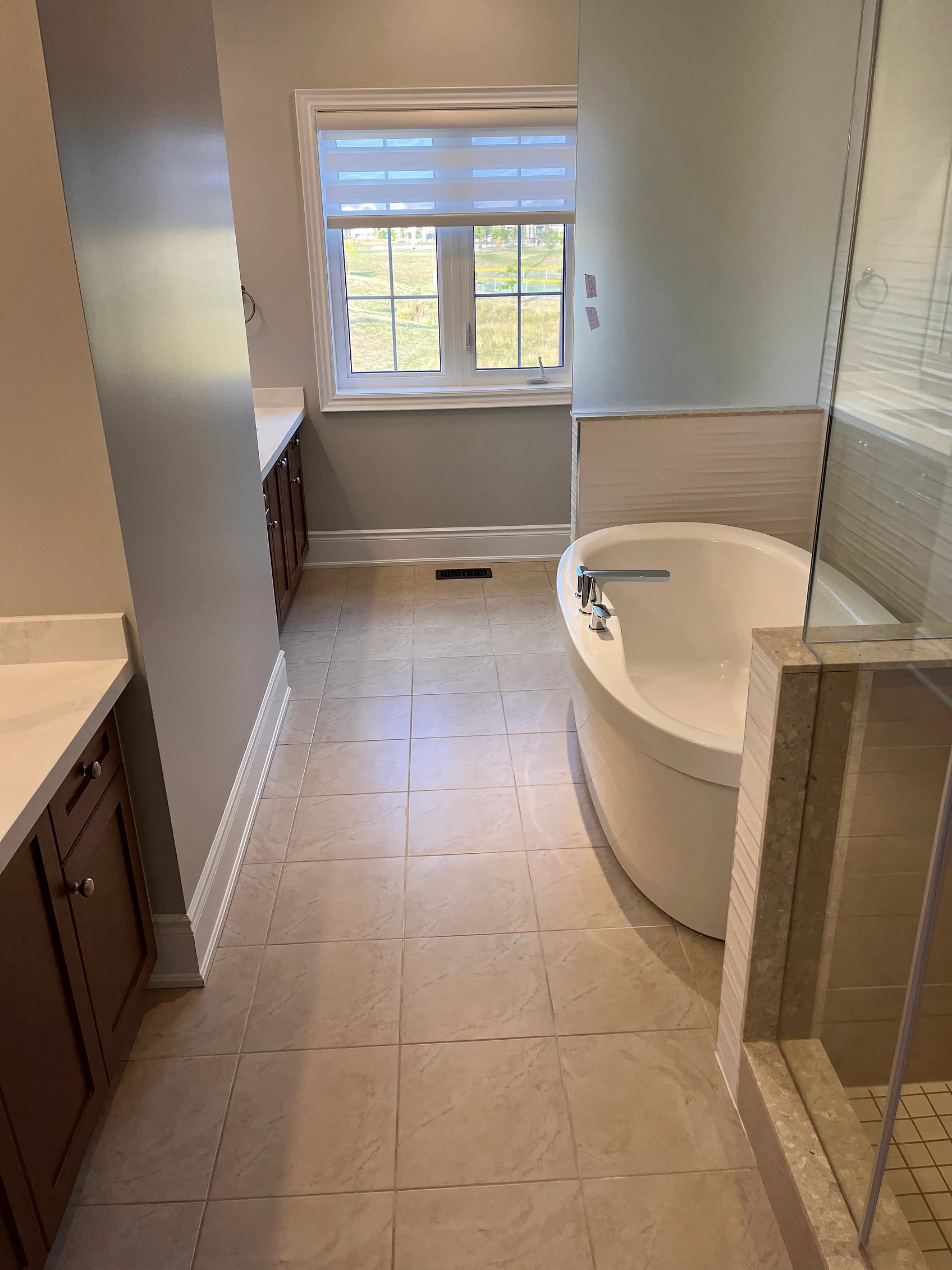 Clean bathroom with jacuzzi and stand up shower